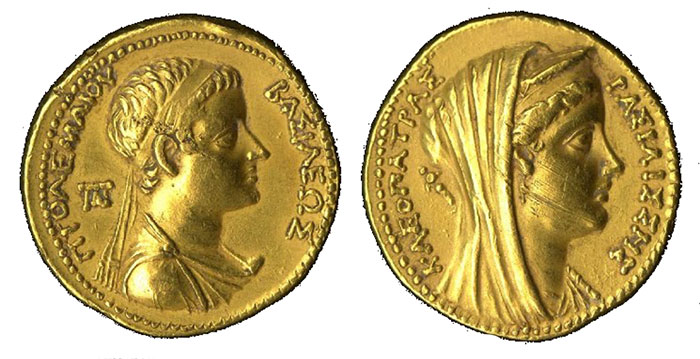 Double-sided gold coin. On the left, one side of the coin displays young Ptolemy VI facing the right, wearing a band in his hair and donning Greek robes. On the right, the other side of the coin depicts Cleopatra wearing a stephane and veil while facing the right in a mirroring manner as Ptolemy VI.