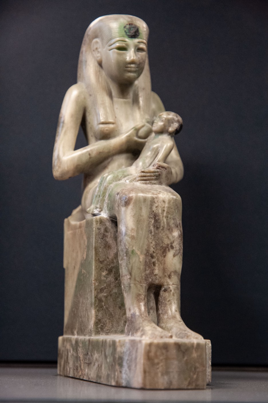 A statue created in Late Ancient Egypt depicting a Mother breastfeeding her infant child.